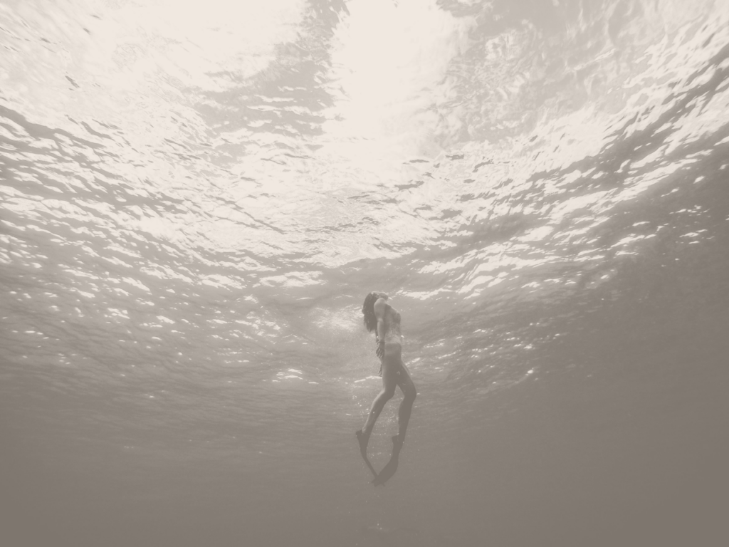 Woman in Water Diving to the surface lonely sacred